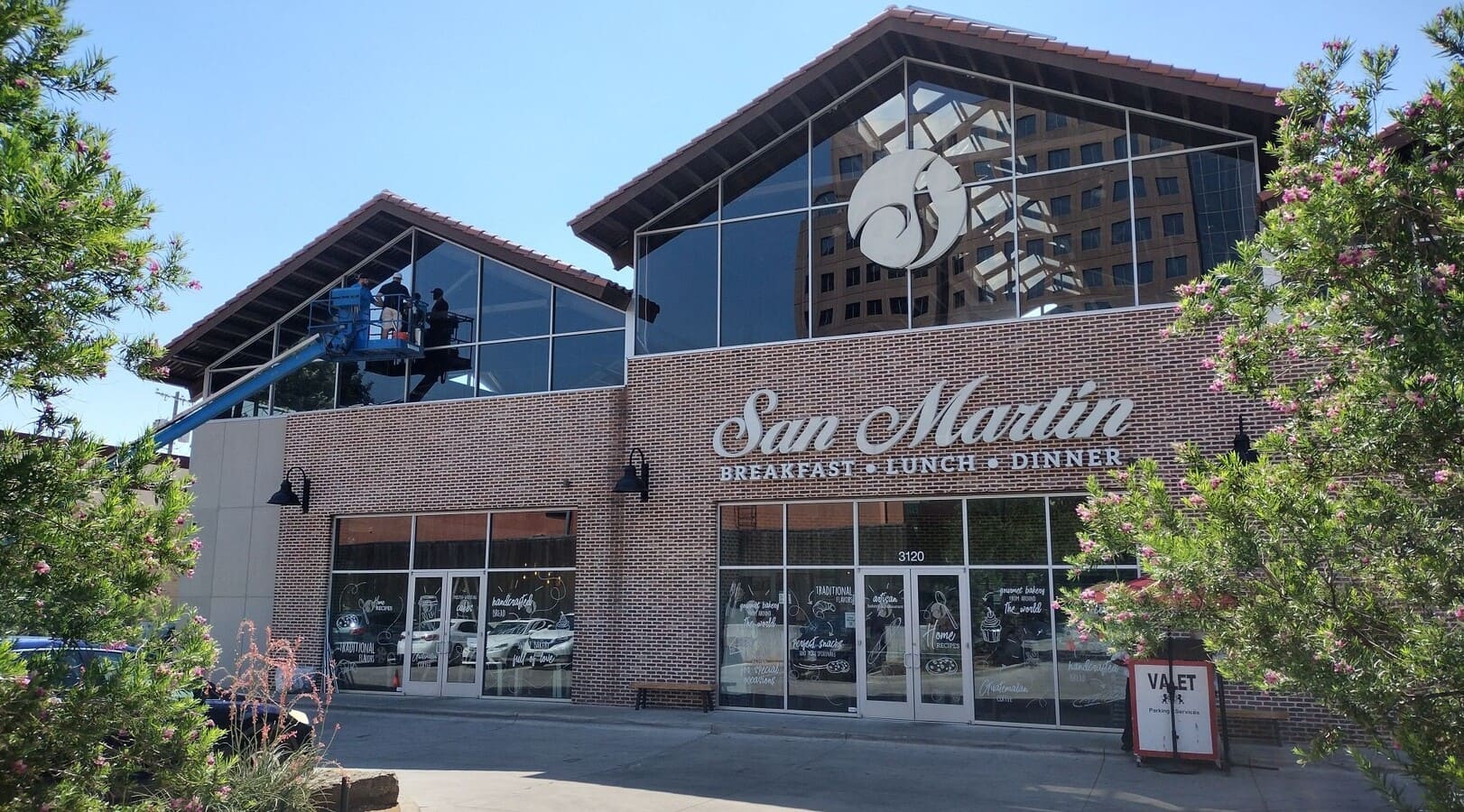 SunMasters Technician Applies Window Tinting to Exterior of San Martin Bakery in Downtown Dallas
