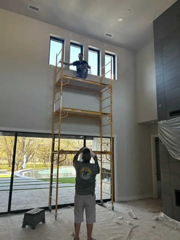Sun Masters crew installing residential window tinting on a two-story home in DFW