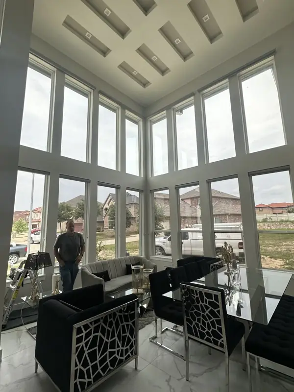 Two-story living room windows, tinted